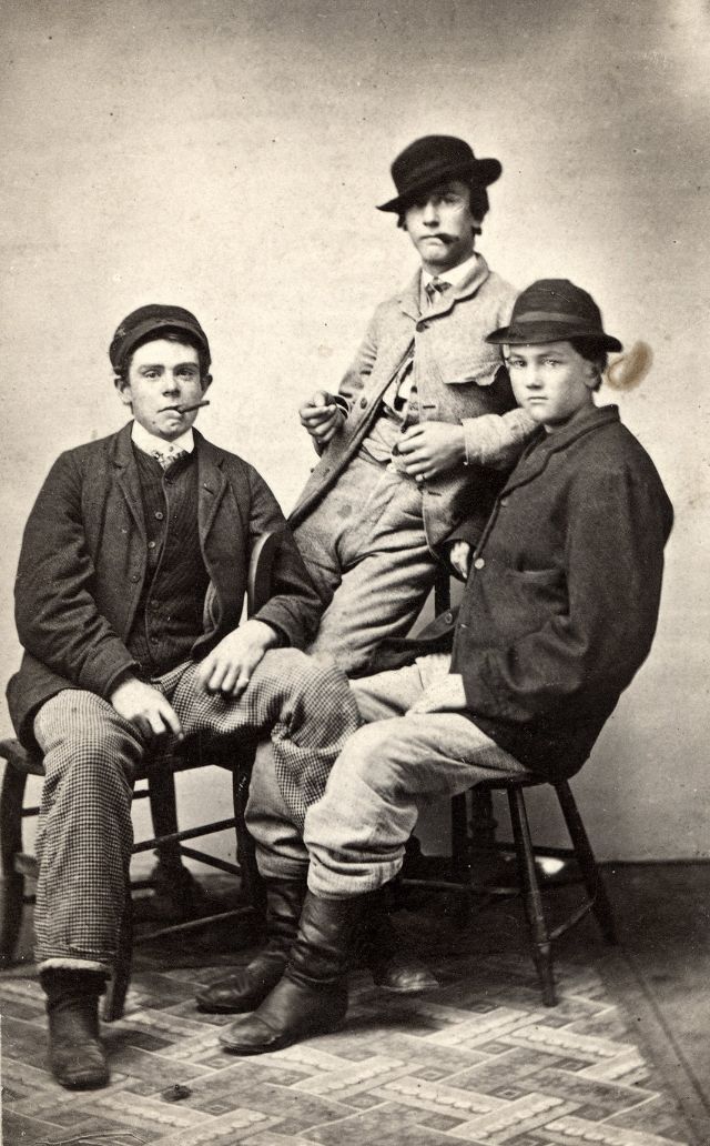 #35 Three men pose for their likeness, two with cigars and one perhaps too young to have picked up the habit