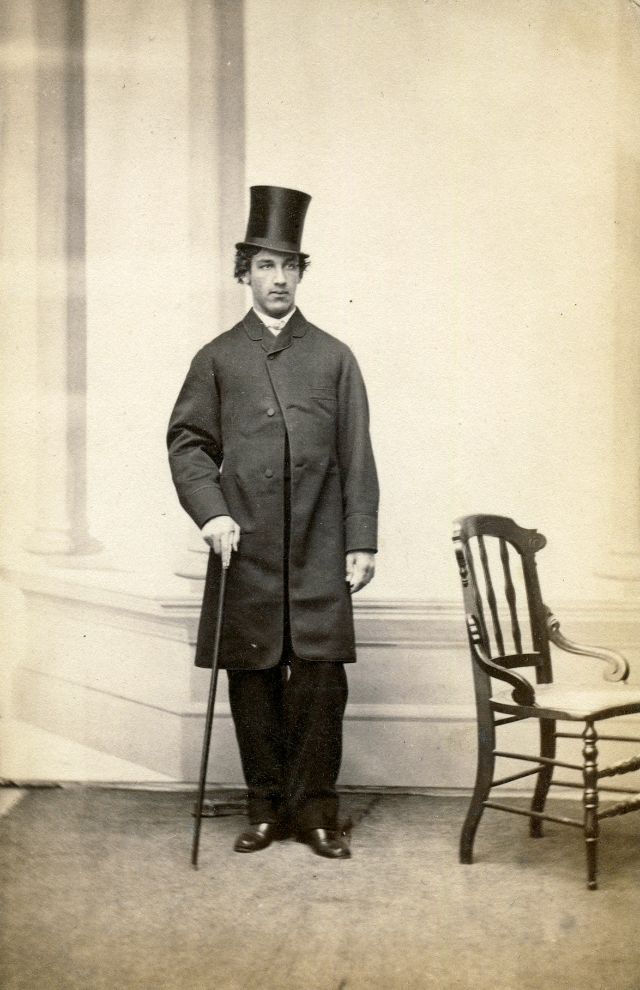 #5 A Maine gentleman strikes a casual pose with frock coat, top hat and cane