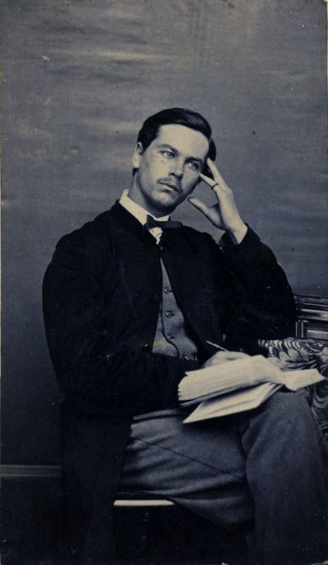 #6 A man gazes away from the camera, forming his thoughts before putting pencil or pen to his journal