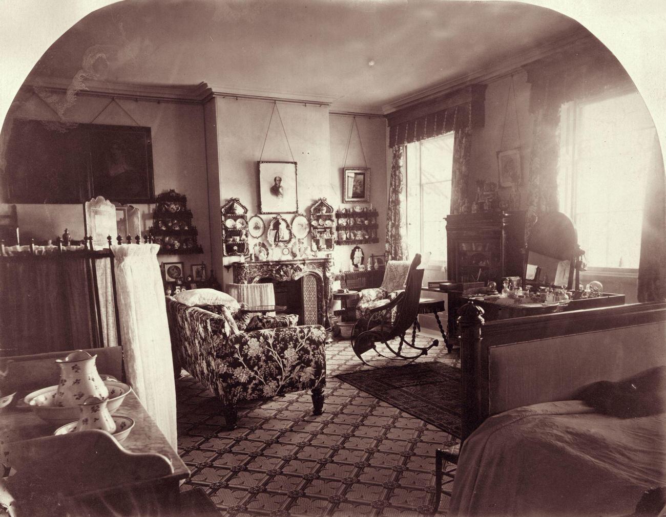 #60 Interior of a living room in Norris Green, 1860, featuring a chintz sofa and shelves of china.