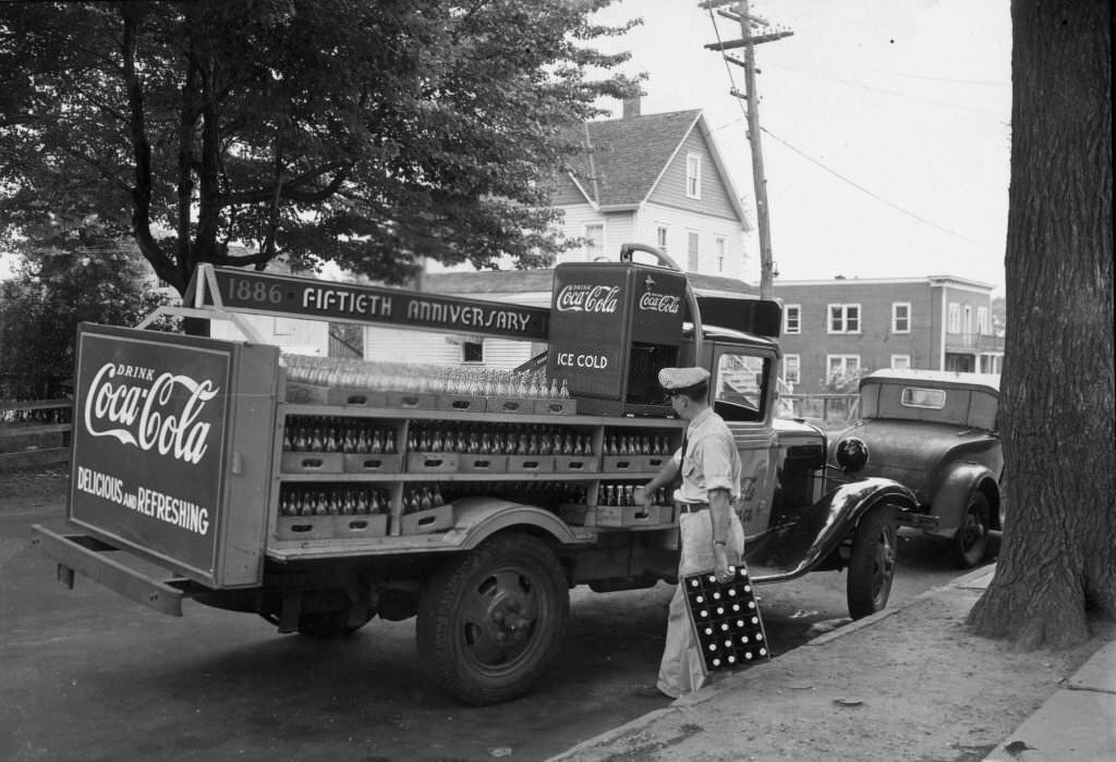 #1 A delivery man unloading cases of Coca-Cola from a truck celebrating the 50th anniversary with a ‘1886 – Fiftieth Anniversary – 1936’ sign.
