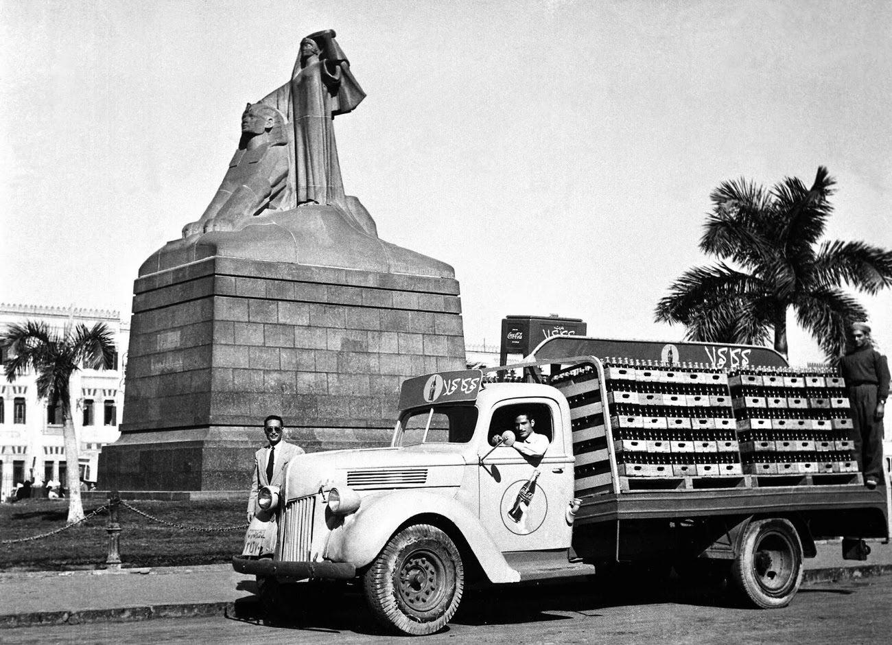 #21 A a Coca-Cola delivery truck next to a statue in Egypt, 1950.