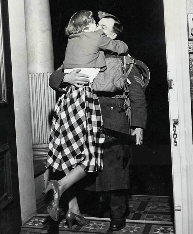 #45 Soldier greeted with kiss from wife, home from France, Christmas.