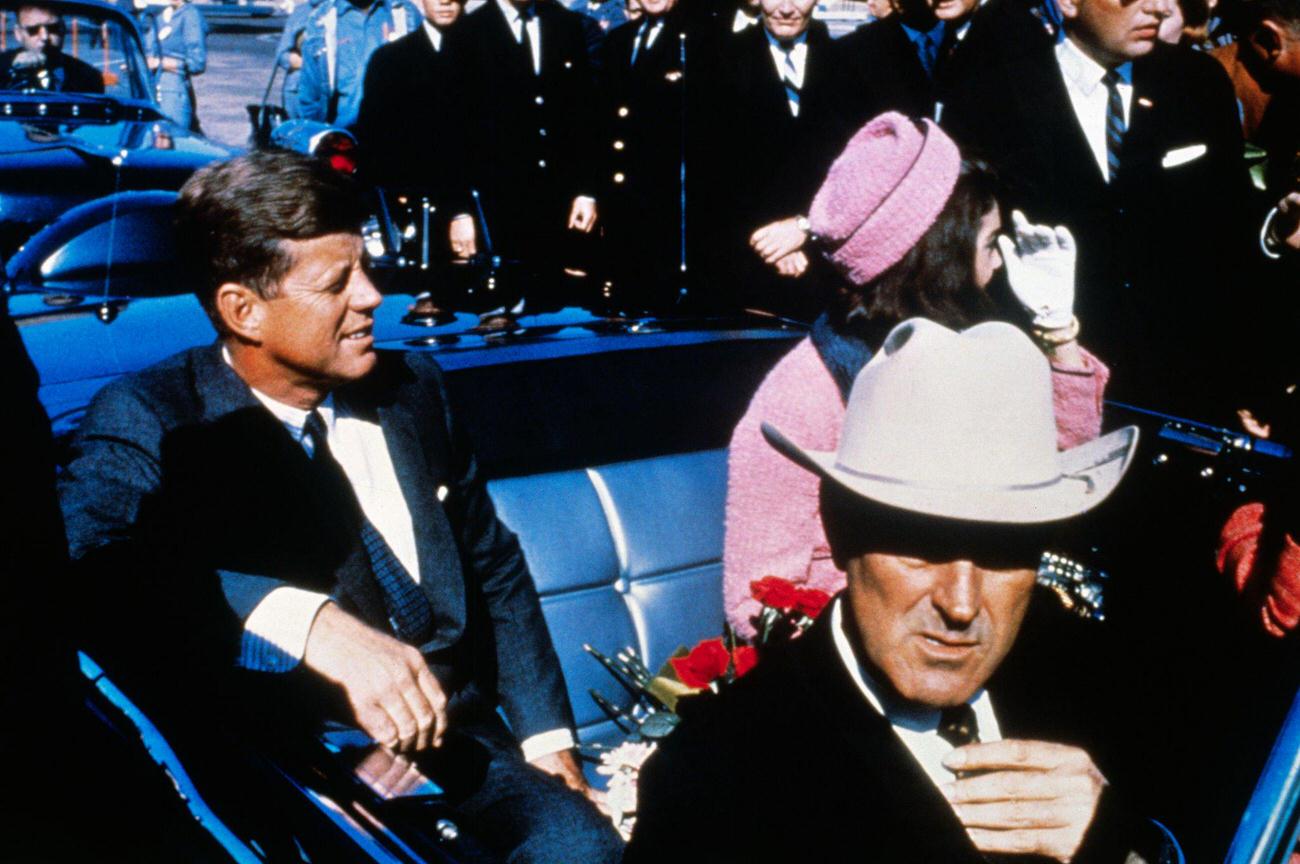 #10 John F. Kennedy, First Lady Jacqueline Kennedy, and Texas Governor John Connally in a motorcade from Dallas airport, 1963.