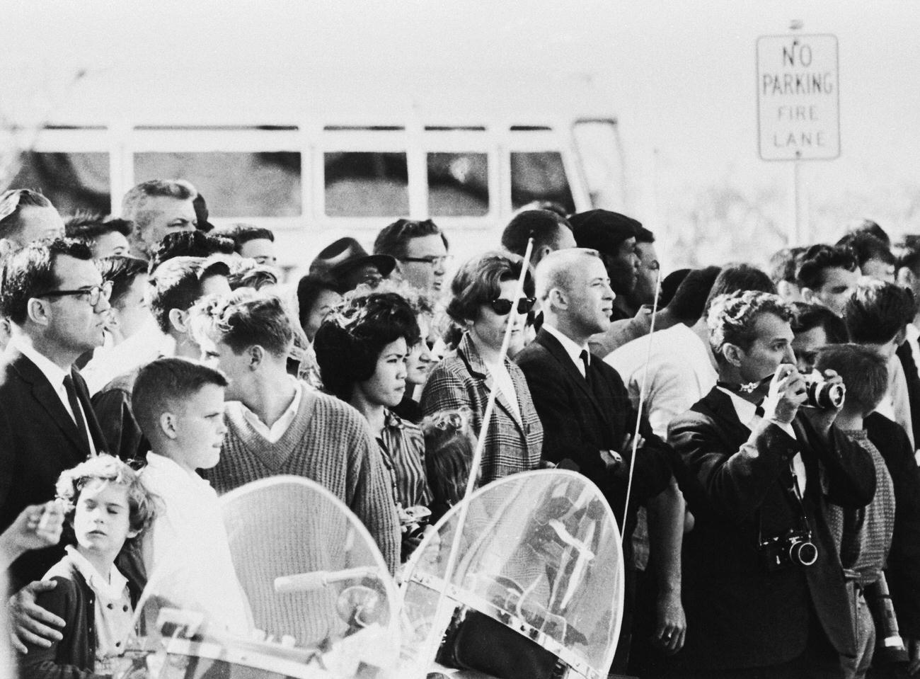 #12 A crowd awaits President Kennedy’s motorcade at Dealey Park in Dallas, Texas, just before his assassination.
