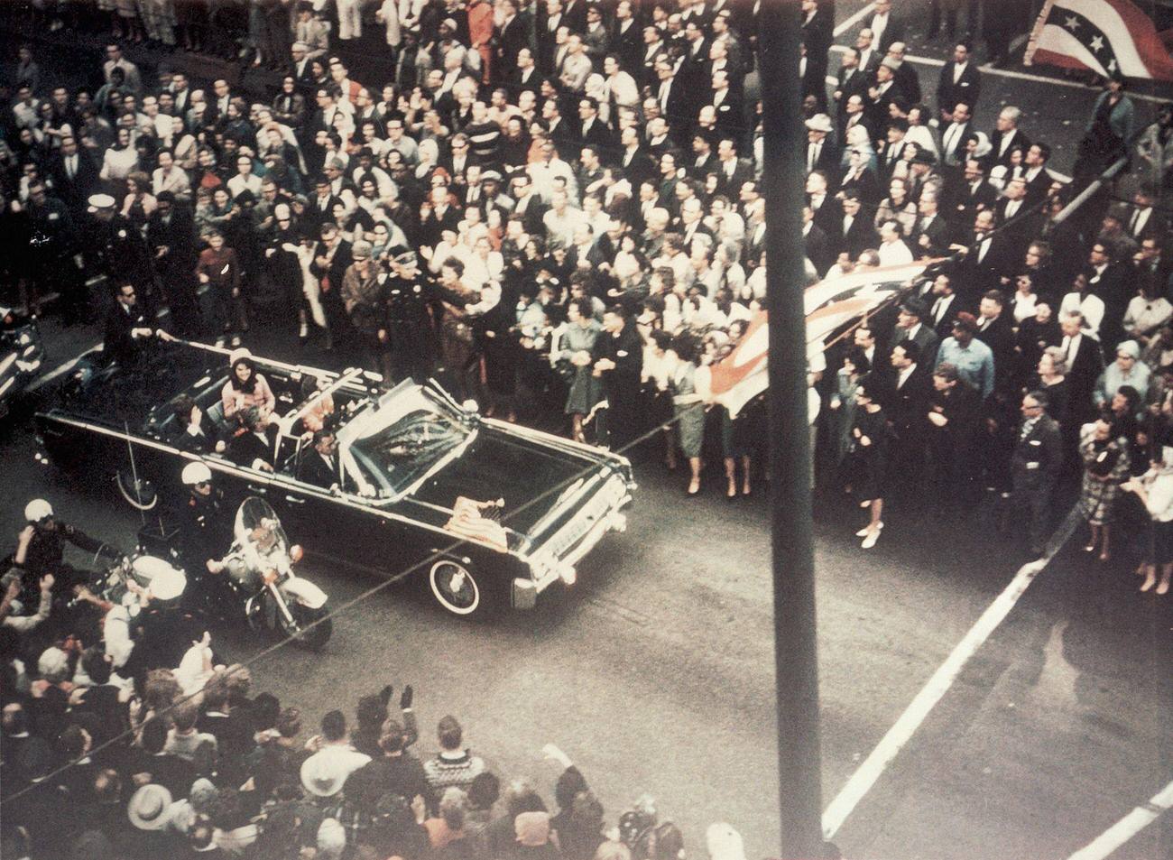 #15 John F. Kennedy, First Lady Jacqueline Kennedy, and Texas Governor John Connally in Dallas streets before the assassination, 1963.