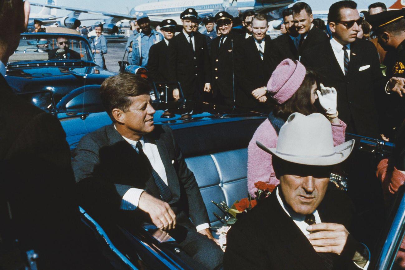 #17 John F. Kennedy with Jacqueline Kennedy and Texas Governor John Connally in a limousine at Dallas Love Field airport, hours before the assassination, 1963.