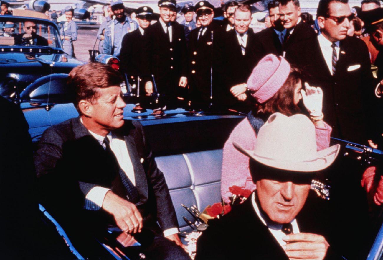 #8 Texas Governor John Connally, US President John F. Kennedy, and First Lady Jacqueline Kennedy prepare for a Dallas motorcade from the airport, 1963.