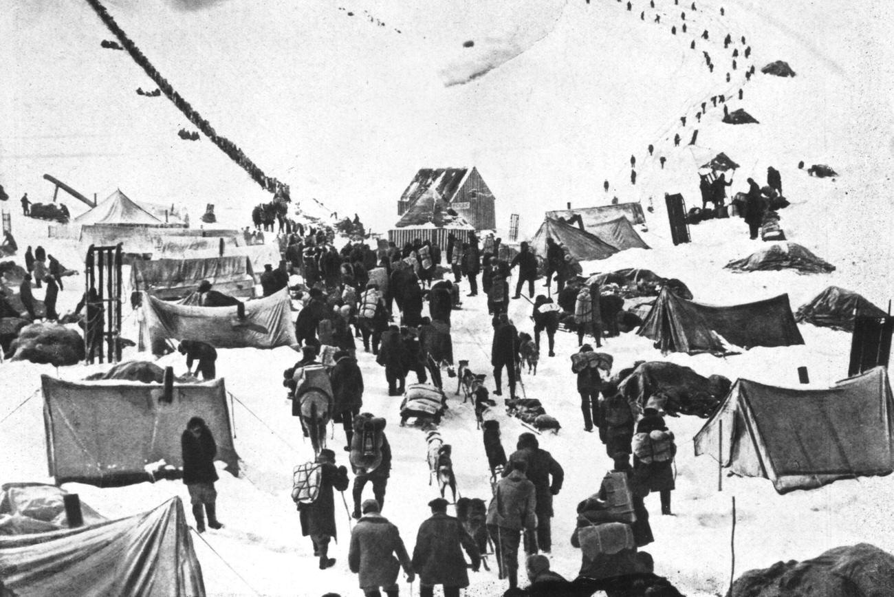 #17 A caravan of prospectors arriving in the snowy Klondike, Canada, to join the Gold Rush, 1895.