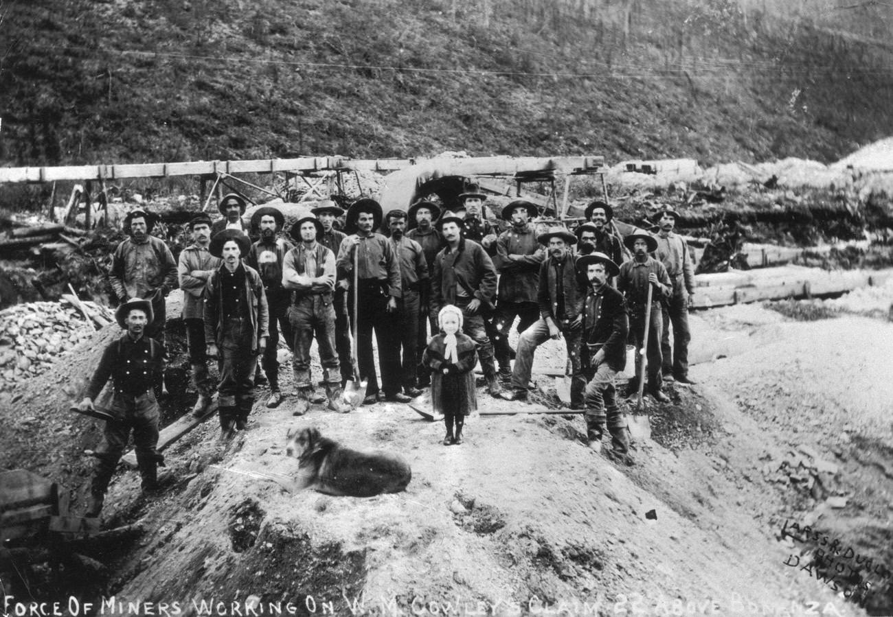 #21 Portrait of gold miners working on W.M. Cowley’s claim in Bonanza, Klondike, Alaska, with a dog, 1897.