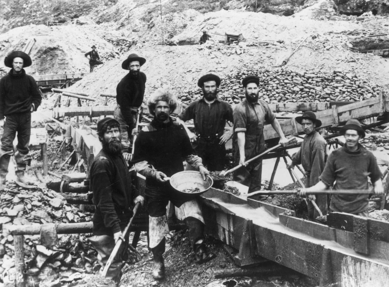 #22 Jubilant miners displaying a large gold nugget during the Klondike Gold Rush, 1897.