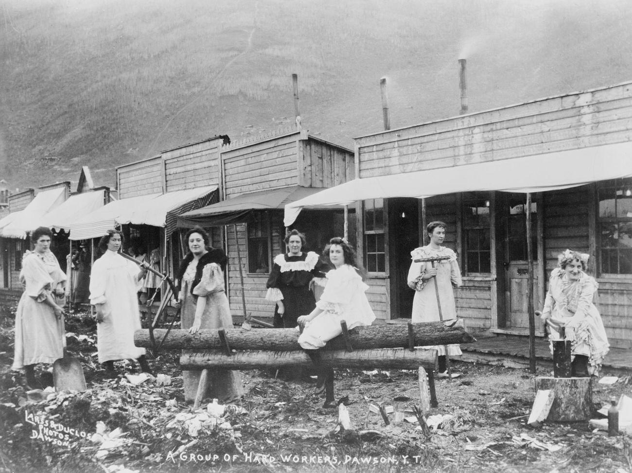 #40 Women sawing logs in Dawson, Yukon Territory, during the Klondike Gold Rush.