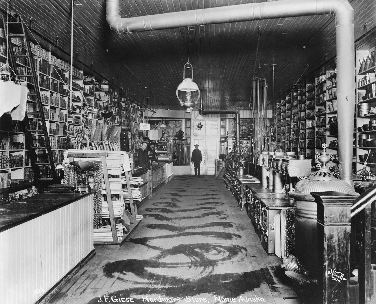 #54 J.F. Giese’s hardware store in Nome, Alaska, during the Klondike Gold Rush, 1904.