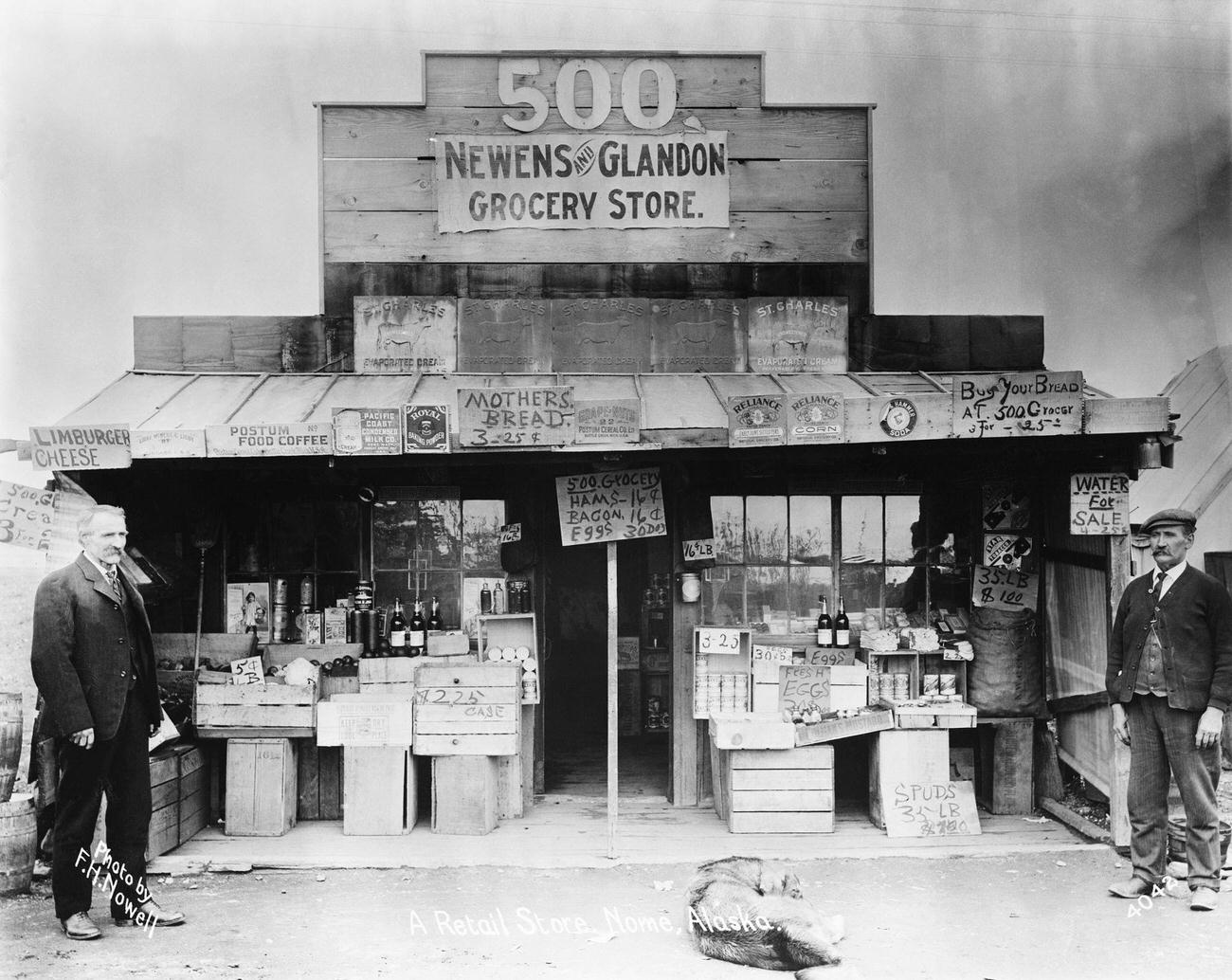 #5 The Newens and Glandon grocery store in Nome, Alaska, displaying a “Water for Sale” sign during the Klondike Gold Rush.