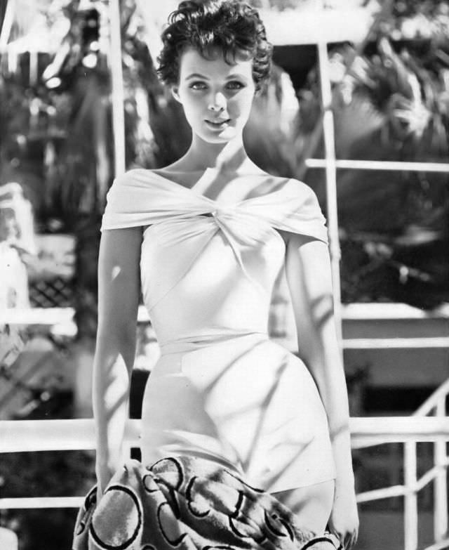 #10 Linda Harper in a white jersey draped bathing suit with sharkskin shorts by Carolyn Schnurer, Haiti, 1954.