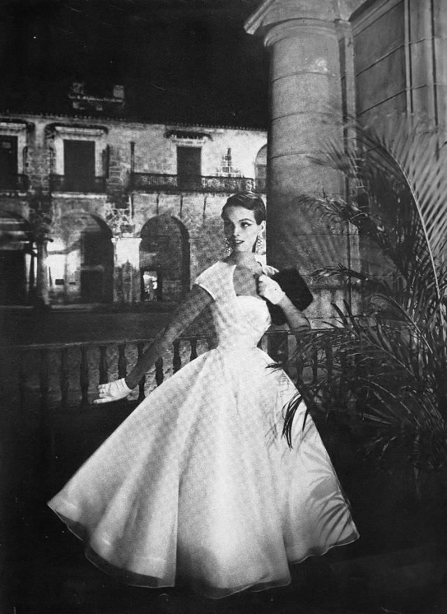 #11 Linda Harper in a white satin dress with a single red rose by Jo Copeland, Havana, 1954.