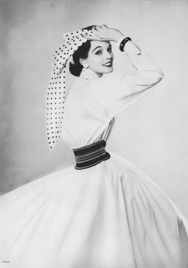#1 Linda Harper in a starch-white sheeting dress with a full-bloused yoke and bright waist garter by Craig, 1952.