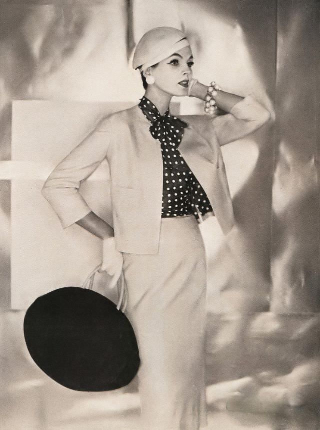 #14 Linda Harper in a blond silk tussah jacket and skirt with a polka-dot blouse by Adele, 1956.