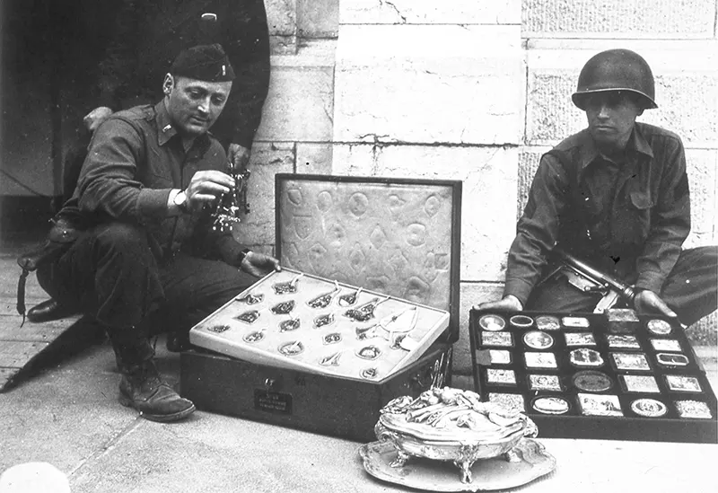 #13 First Lieutenant James J. Rorimer, Sergeant Antonio T. Valin with recovered objects, Neuschwanstein, Germany, May 1945.