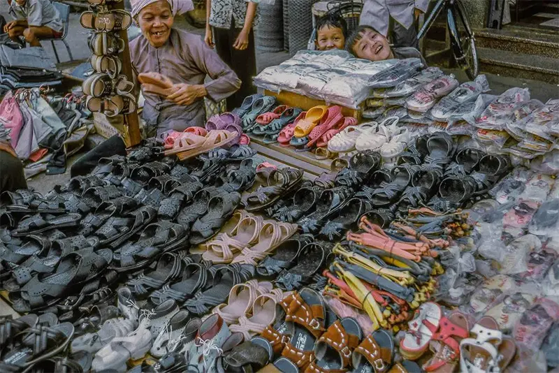 #14 Shoe seller with children, My Tho market, 1969.