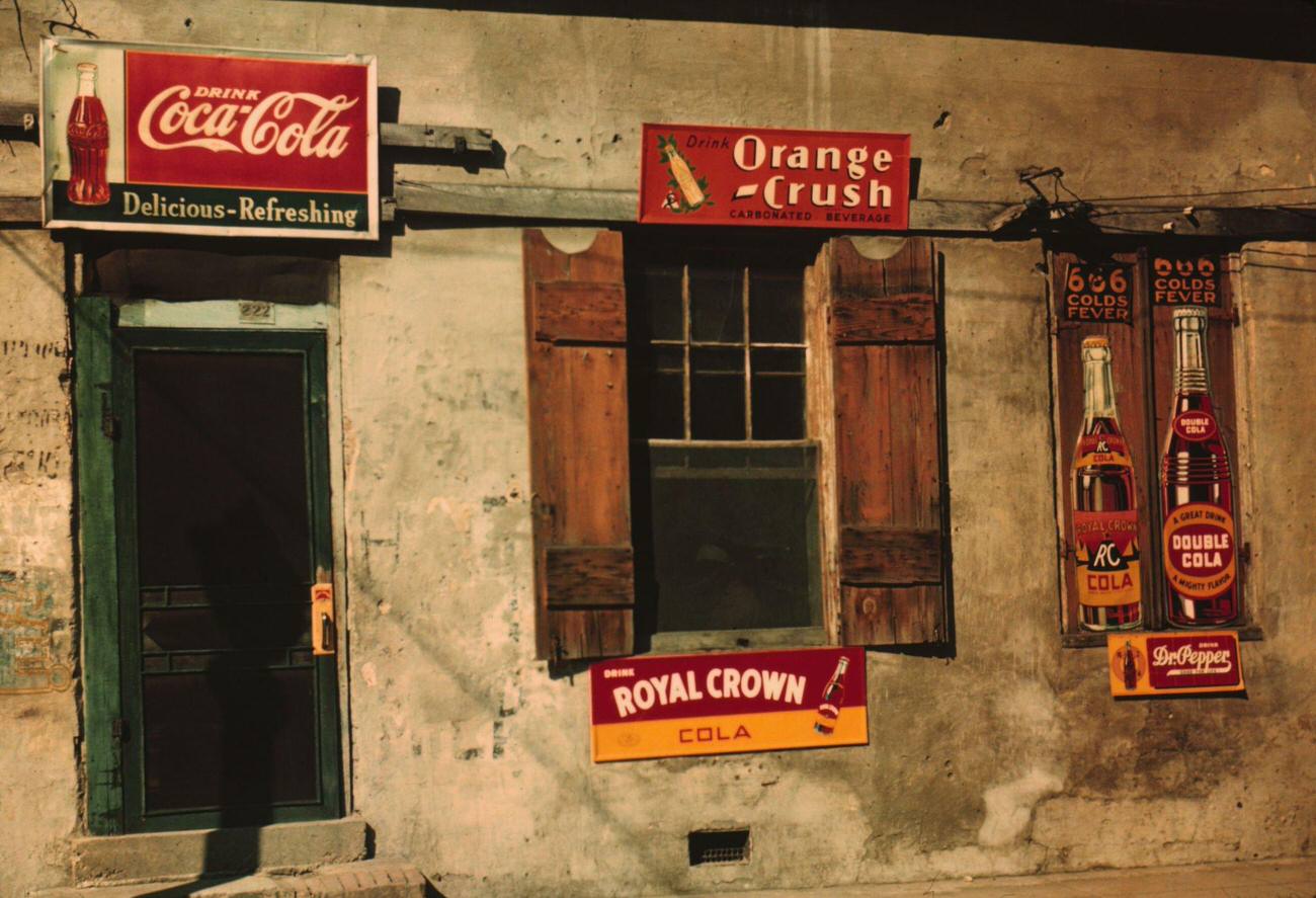 #20 Natchez, Mississippi, featuring signs for Coca-Cola, Orange Crush, and Royal Crown cola.