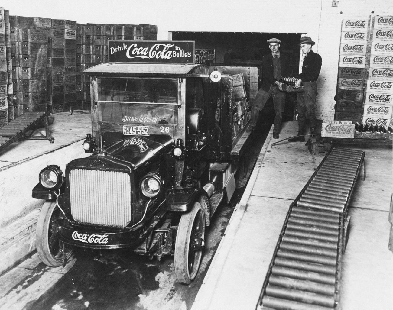 #25 Workers loading crates of Coca-Cola onto a truck, circa 1930.