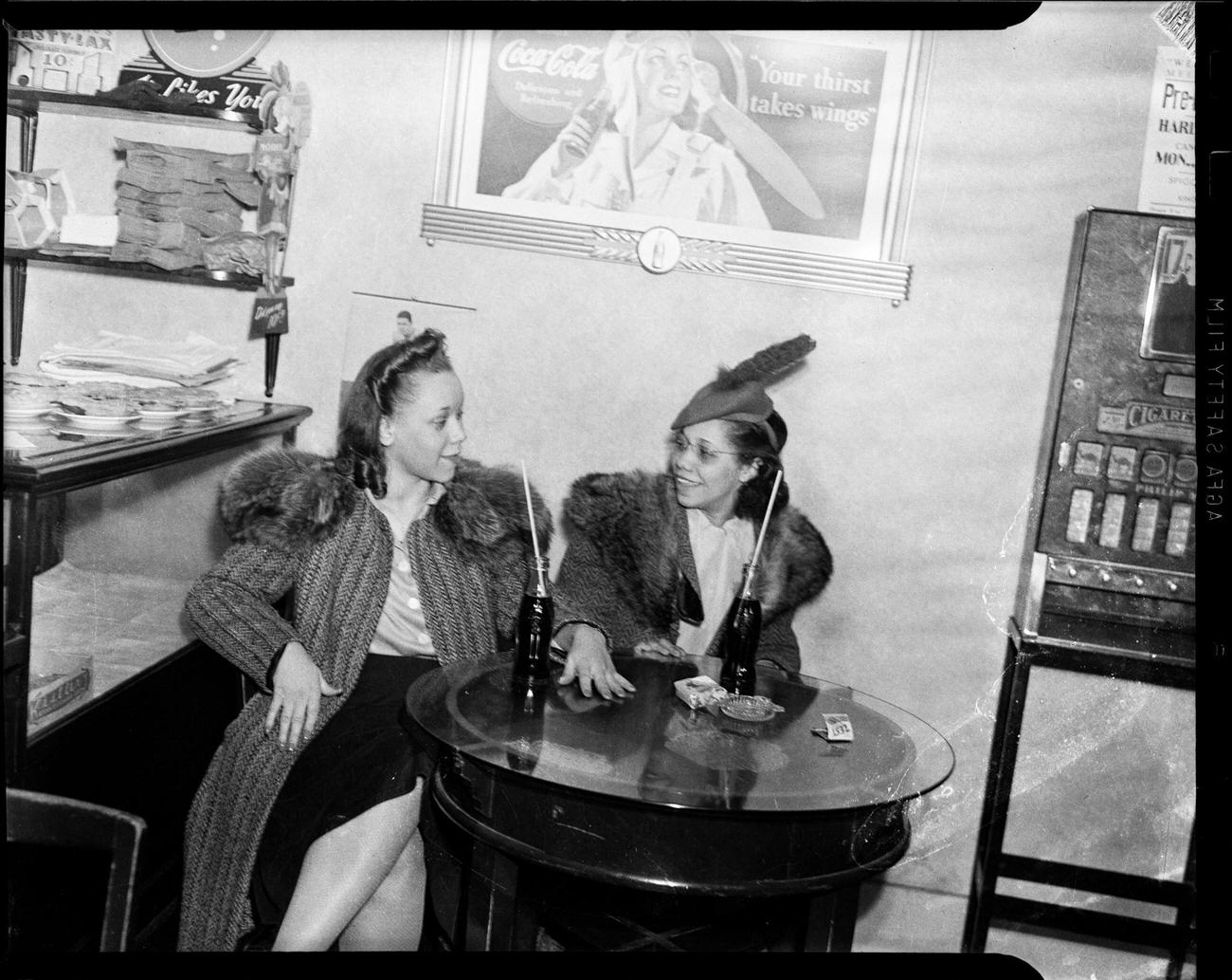 #41 Ella Mae Lacey and Myrtle Thomas with Coca-Cola bottles in Lincoln Lunch Restaurant, Washington, Pennsylvania, March 1941.