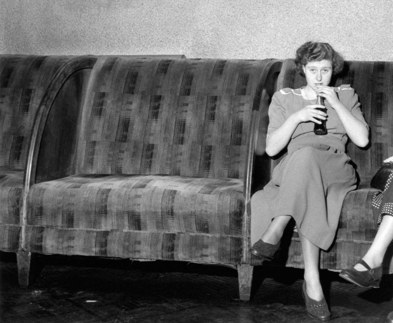 #55 Woman sitting and drinking Coca-Cola in London, United Kingdom, 1950.