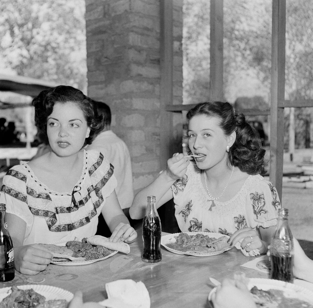 #9 Two Mexican girls at lunch during a festival in Tijuana, Mexico, March 15, 1950.