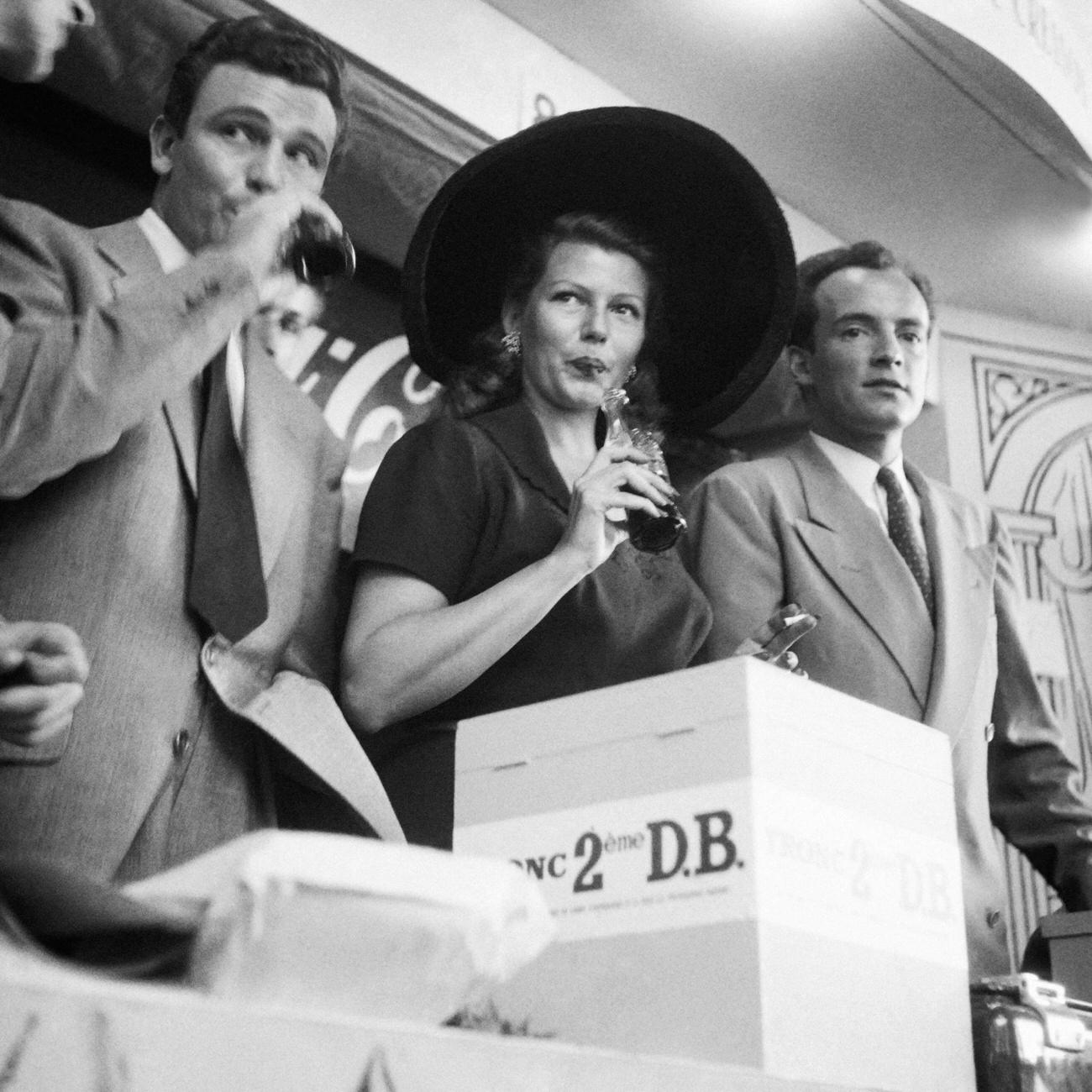 #67 Actress Rita Hayworth drinking Coca-Cola at a fair in Paris, June 10, 1950.
