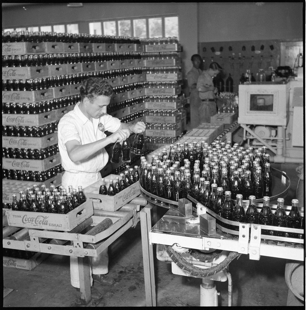 #68 Coca-Cola worker at a bottling plant in Zurich, 1950.