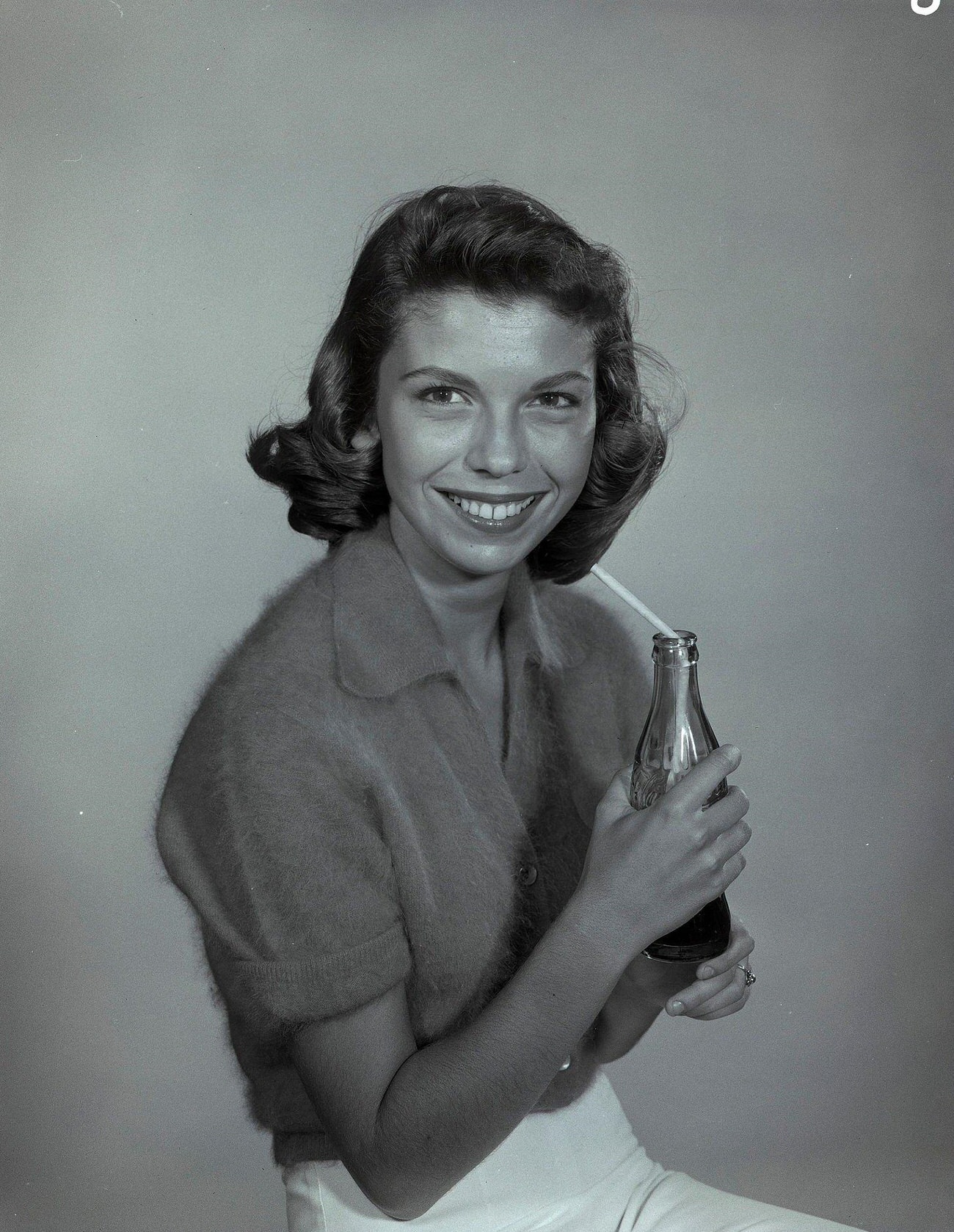 #89 Nancy Sinatra holding a Coca-Cola bottle on “The Frank Sinatra Show,”, 1957.