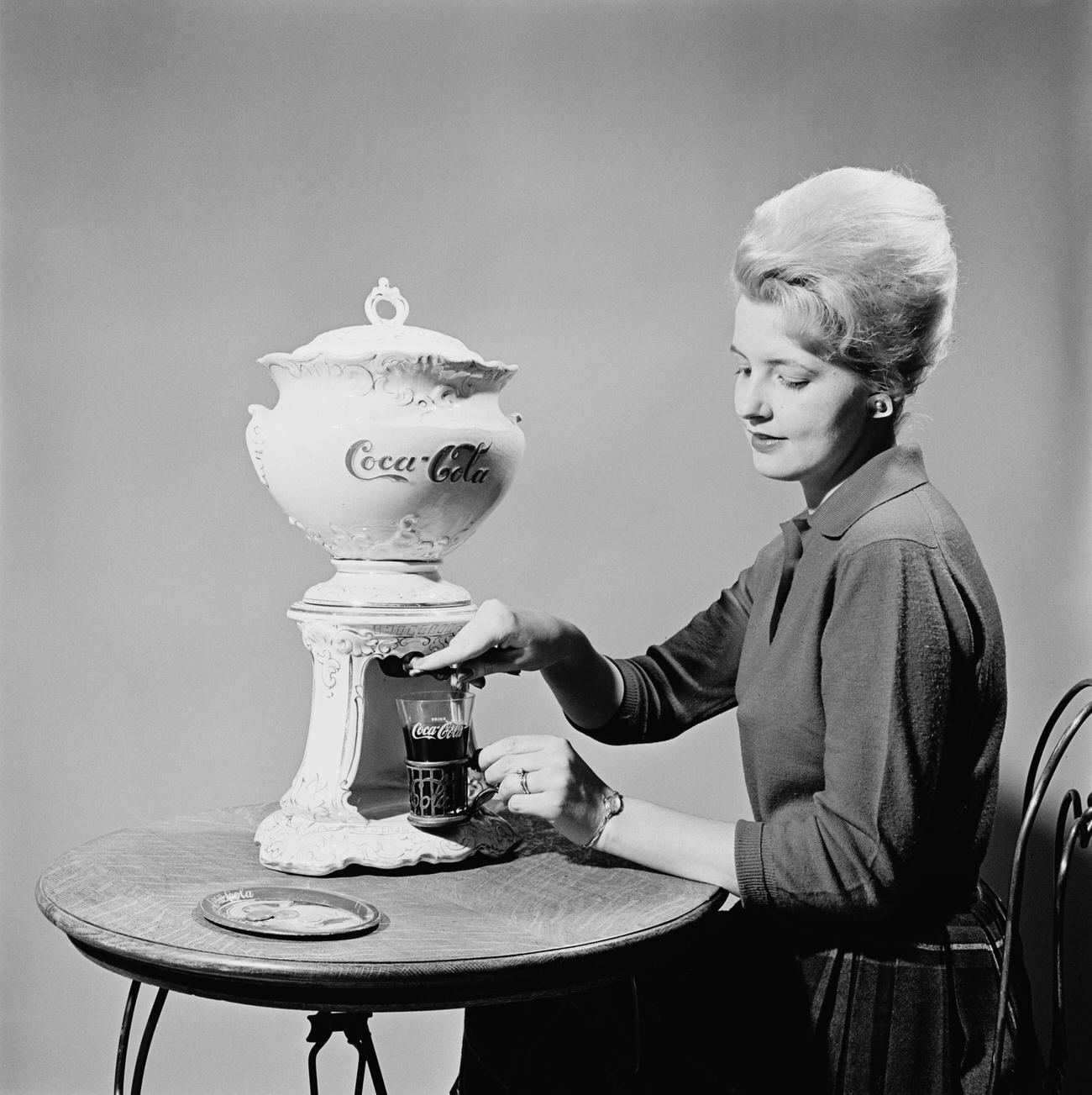 #93 Woman pours Coca-Cola from a samovar at the Coca-Cola Museum in Atlanta, Georgia, circa 1960.
