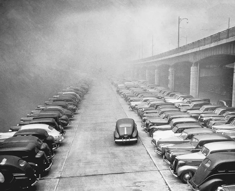 #2 Cars parked on Monongahela Wharf under an overpass in smoke.