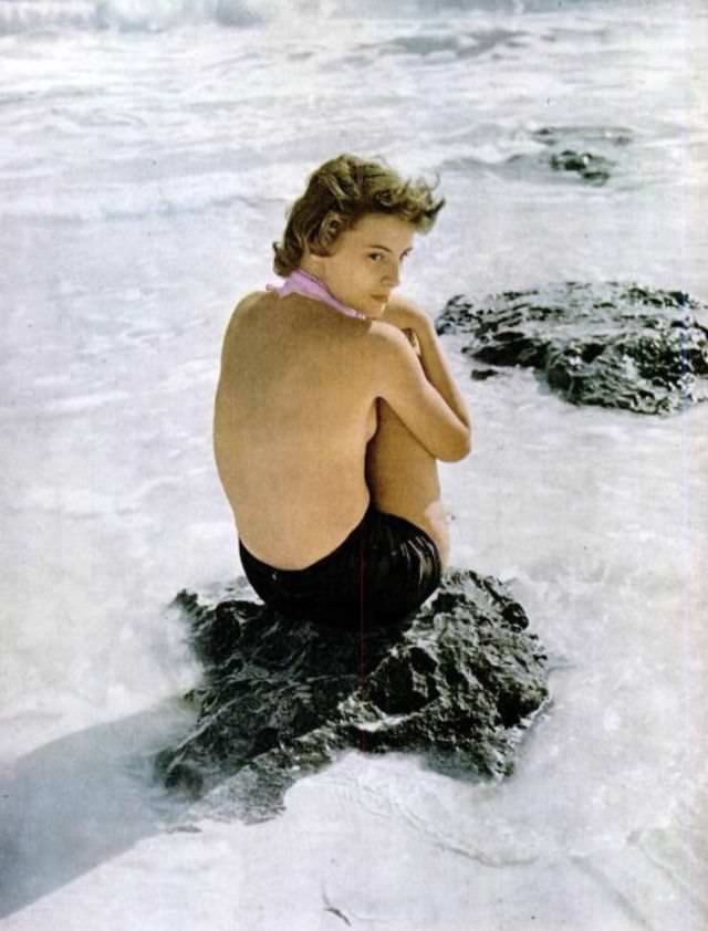 #18 Model in shorts and a pink scarf convertible to a strapless bra, designed by Tina Leser, in Bermuda, 1948.