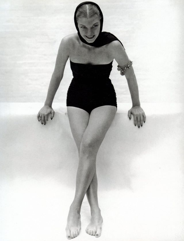 #7 A model in a strapless black wool jersey suit with a matching headscarf and bracelets by Tina Leser, Vogue, 1945.