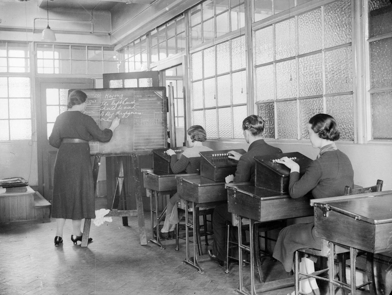 #30 Class learning to key telephone calls to automatic exchanges, Telephone House, Salford, February 1937.