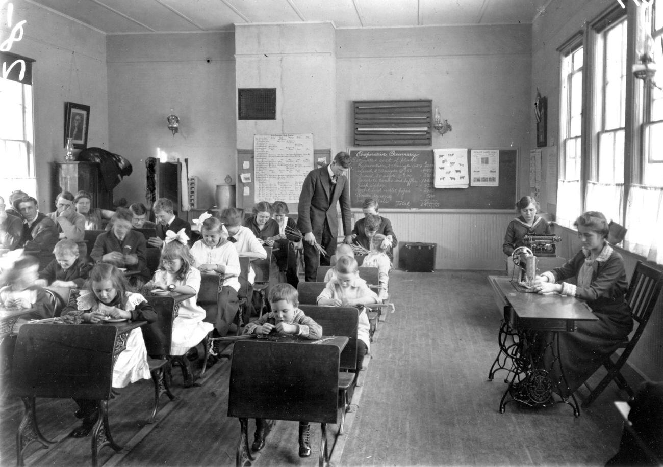 #5 Students learning in a one-room schoolhouse, Wisconsin, early 1900s, including sewing and typing.