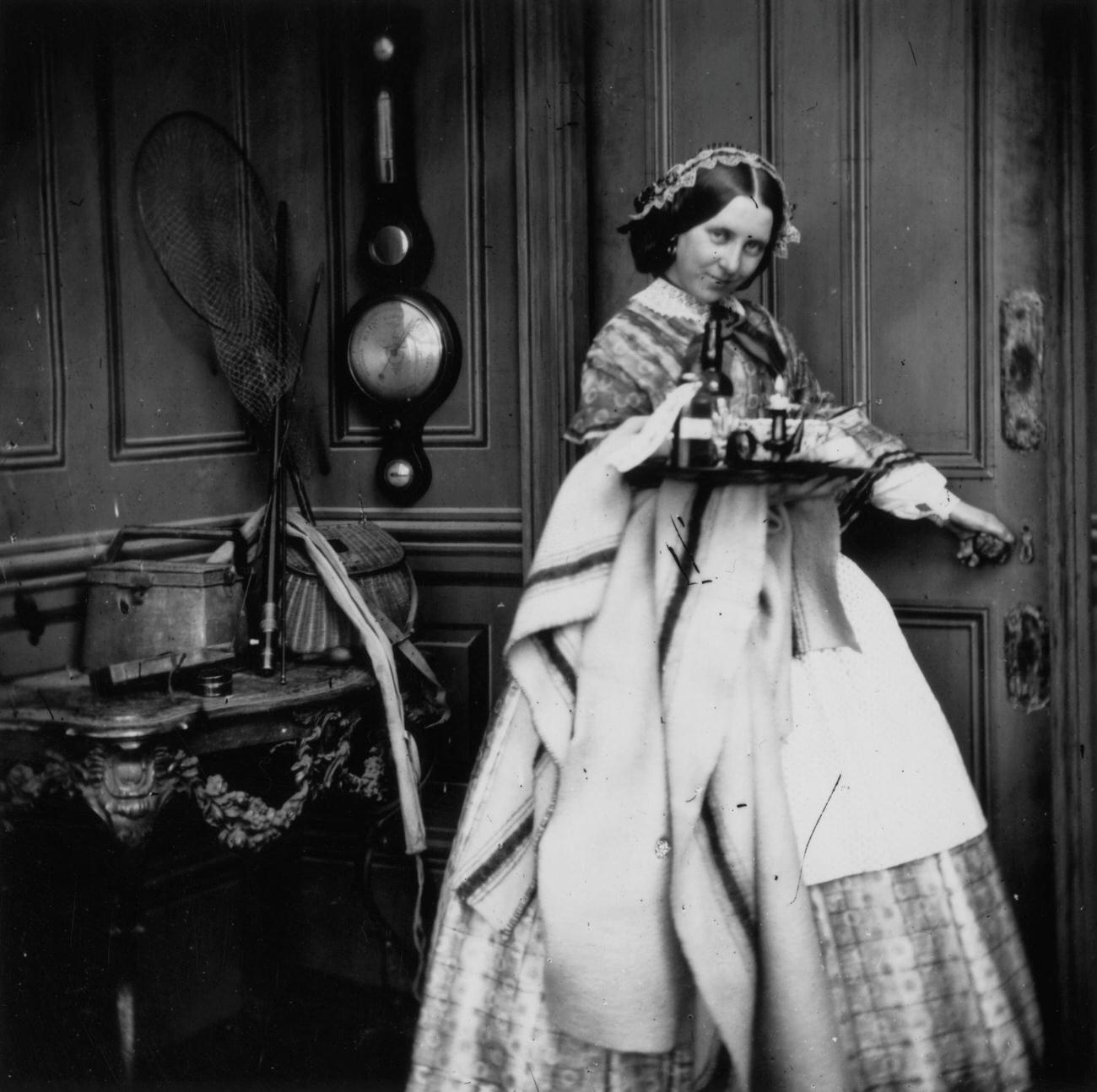 #96 A Victorian servant carrying a tray, circa 1860.