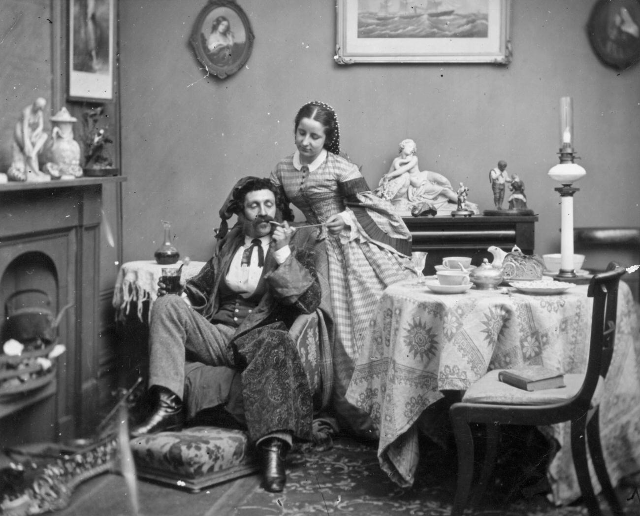 #103 A pampered Victorian husband and his wife, circa 1865.