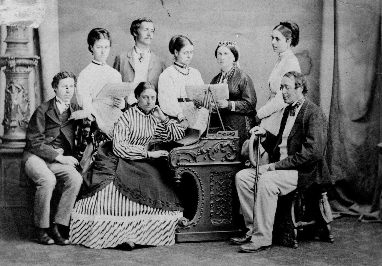 #104 A Victorian family gathered around the piano, circa 1865.