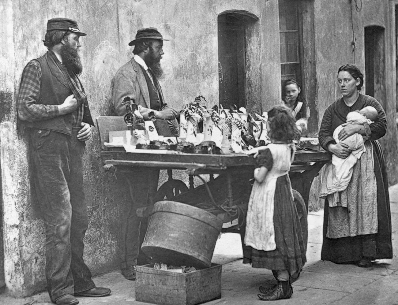 #109 Victorian fancy wear dealer selling ornaments from his barrow, 1877.