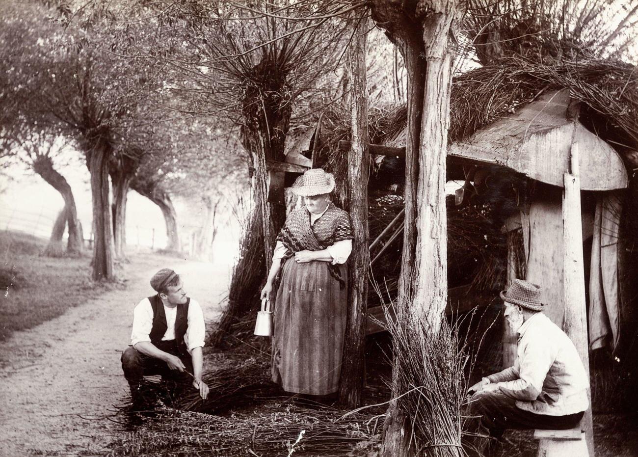 #21 Two men tying bundles of twigs in England, circa 1890.