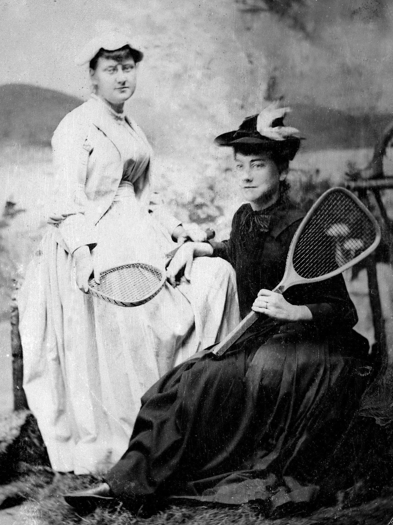 #29 Two women posing with tennis racquets, circa 1890.