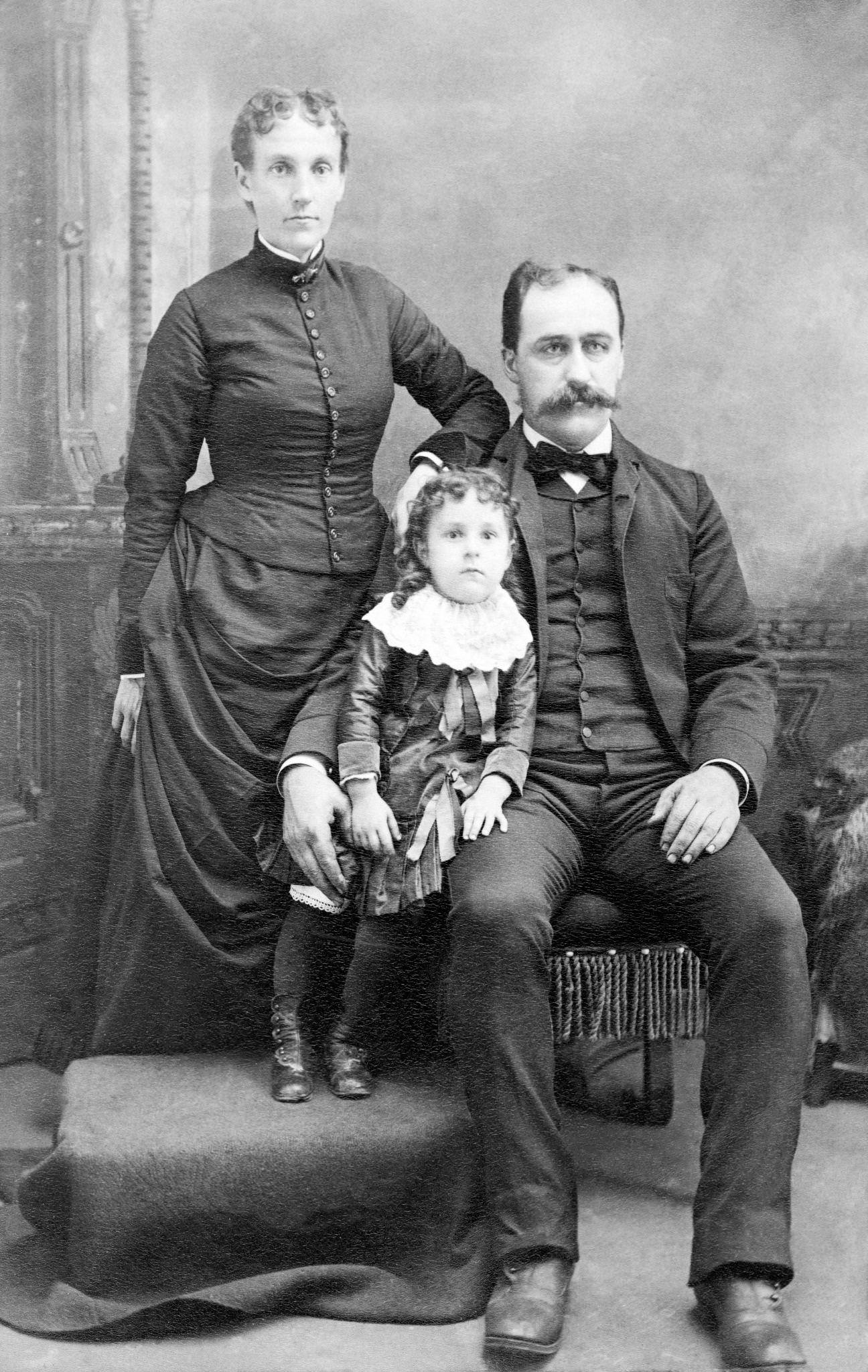 #32 Victorian family with a child in a studio portrait, 1890s.