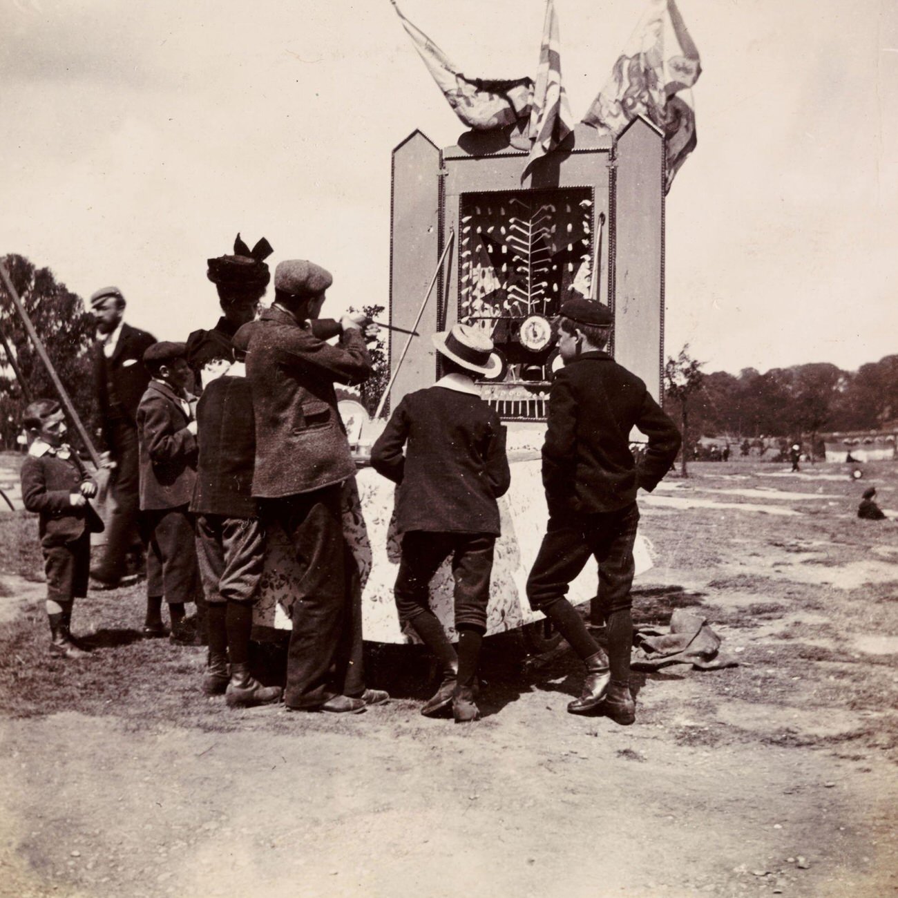 #48 Man aiming at clay tobacco pipes at a fairground, circa 1898.