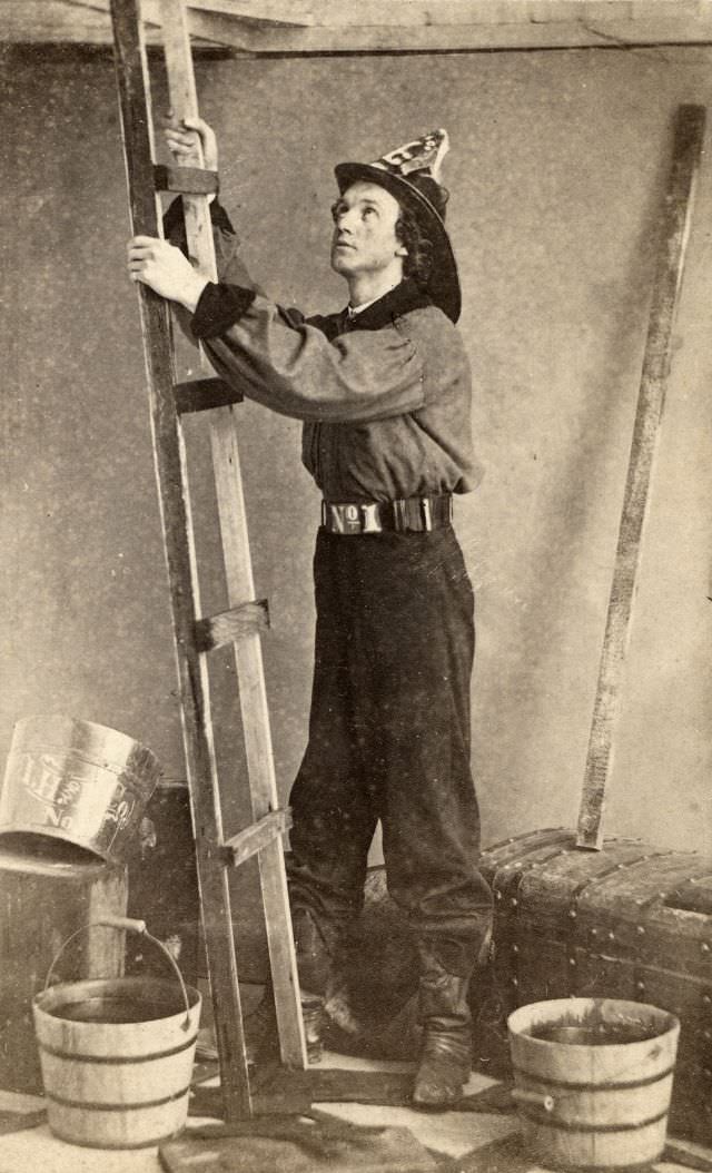 #47 A fireman reenacts a scene as he prepares to climb a ladder