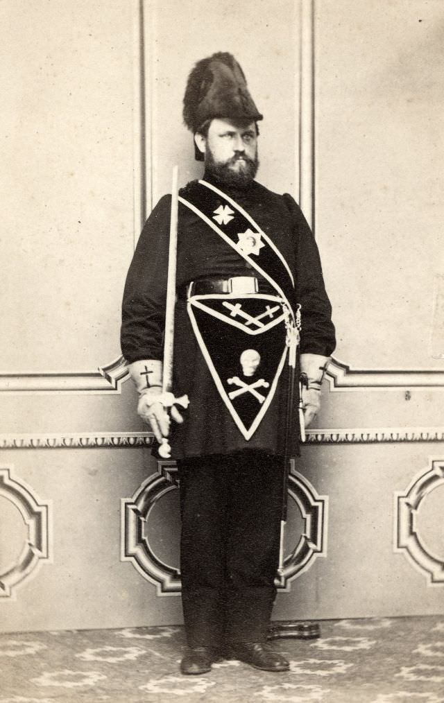 #50 A man is dressed in the regalia of the Knights Templar, a masonic organization that thrived in 19th century America