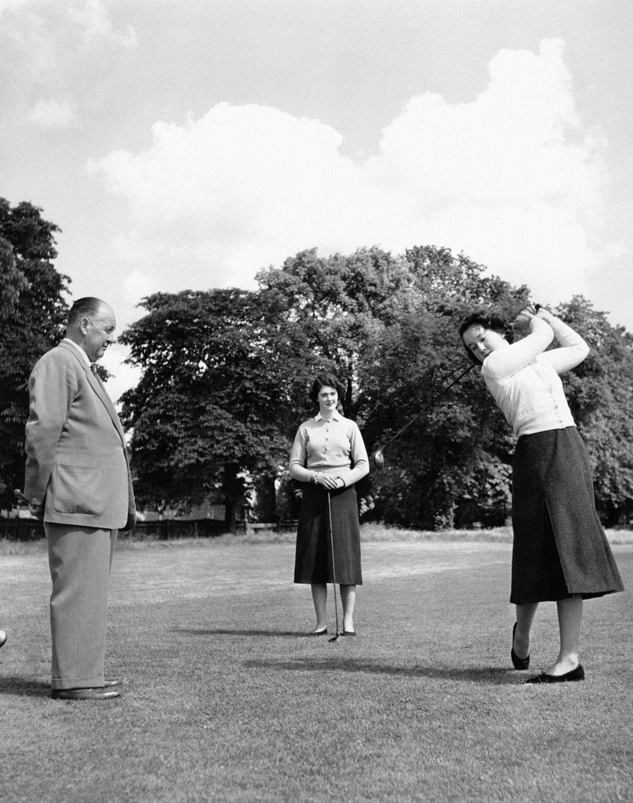Young women learning golf at ‘Cygnets House,’ London, UK.