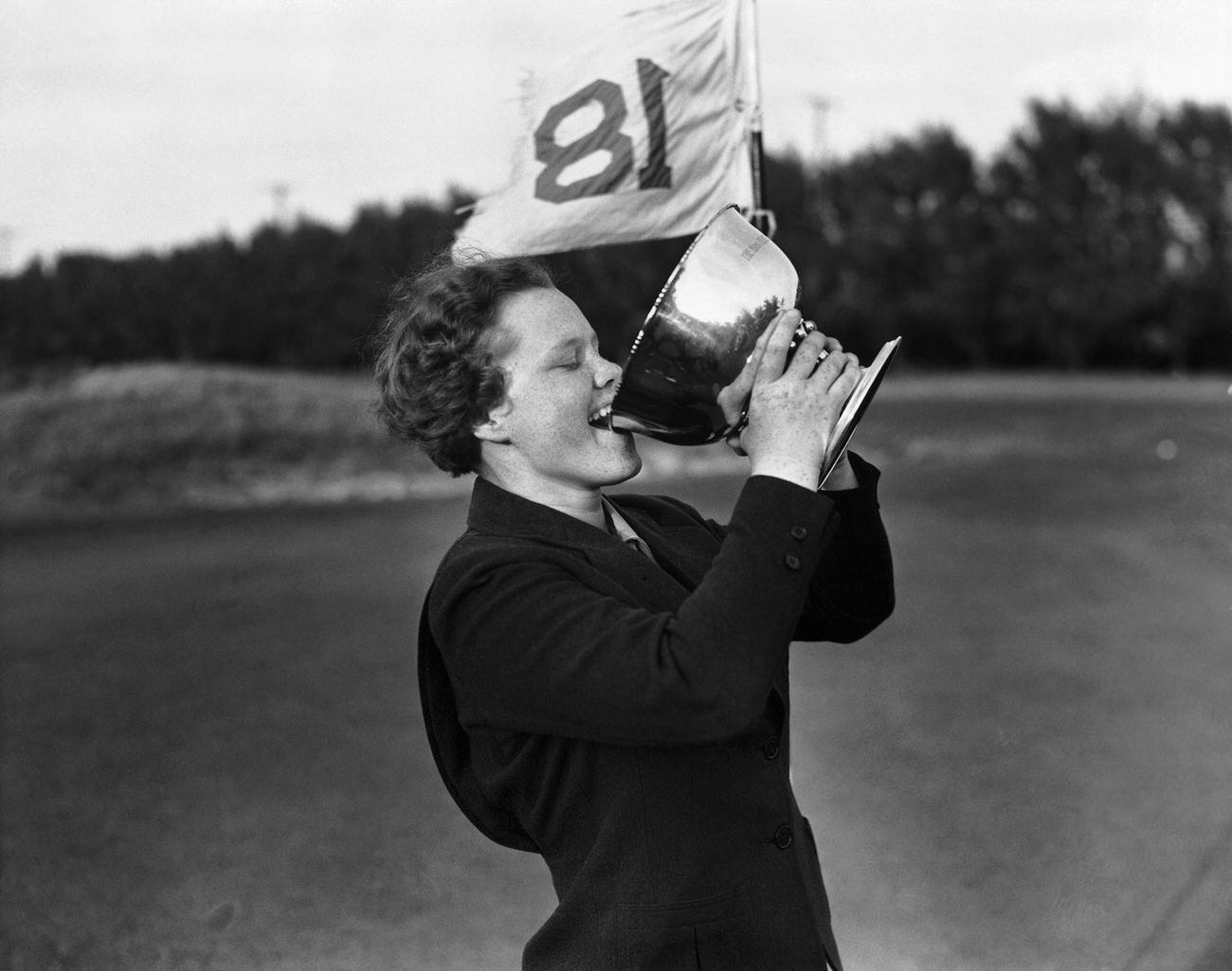 Patty Berg drinking from trophy at Palm Beach Women’s Golf Championship.